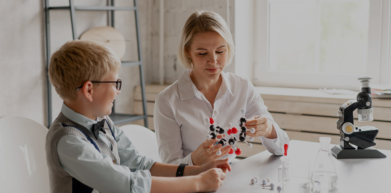 Female science tutor in Dublin studying chemistry with student